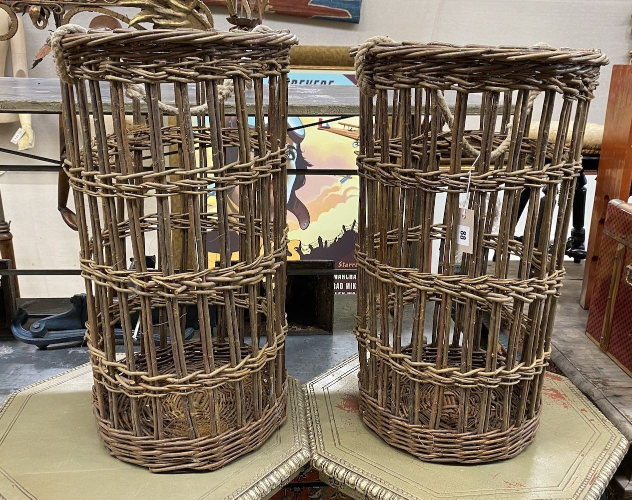 A pair of circular wicker baskets with rope handles, height 70cm